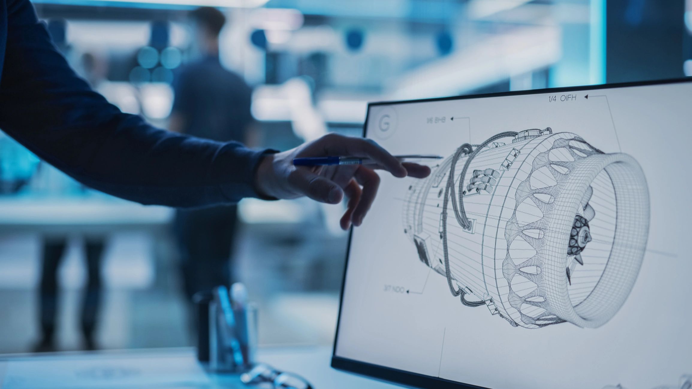 Engineer reviewing technical design on monitor